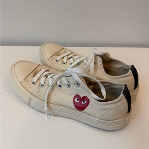 Women’s size 8 men’s size 6 Comme des garçons converse in off white.